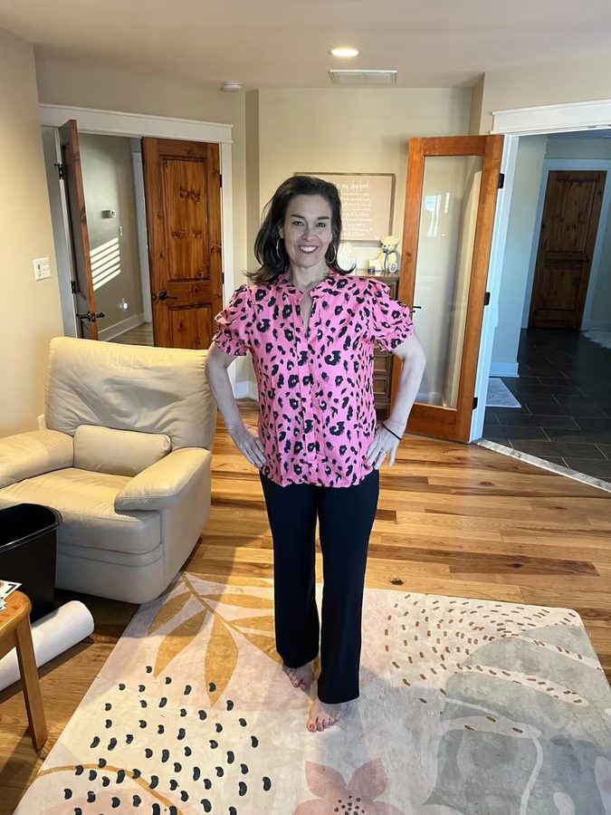 Customer with pink floral blouse and black wide-leg pants